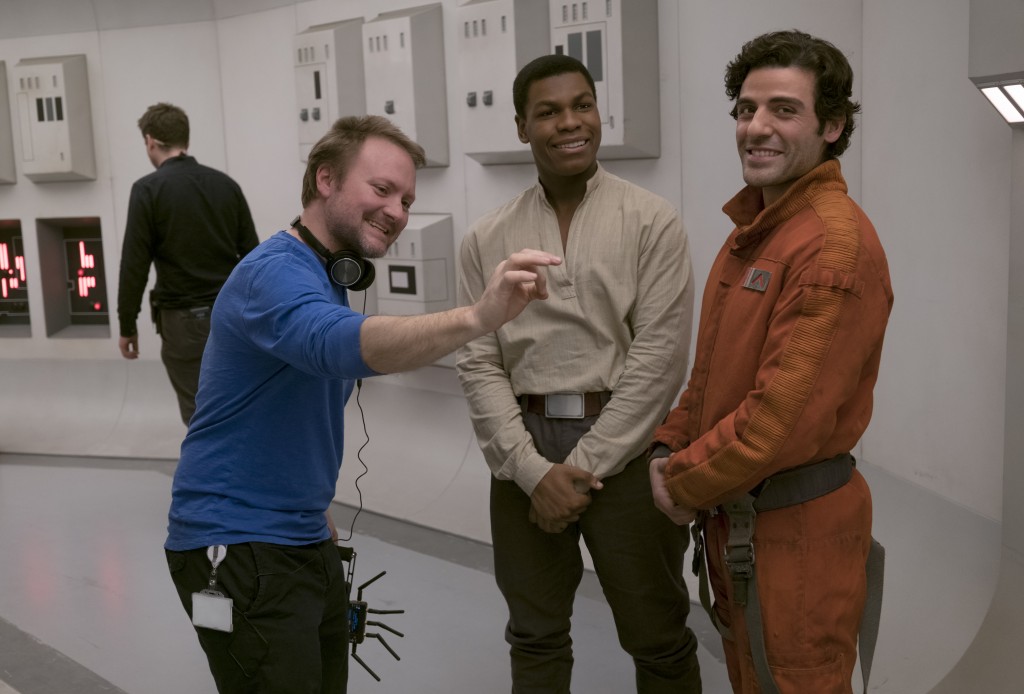 Star Wars: The Last Jedi..L to R: Director Rian Johnson on set with John Boyega (Finn) and Oscar Isaac (Poe Dameron)..Photo: David James..©2017 Lucasfilm Ltd. All Rights Reserved.