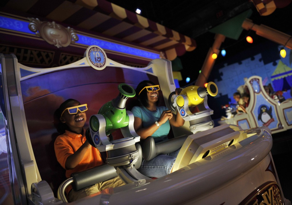 TOY STORY MANIA -- Donning 3-D glasses and manning "spring-action shooters," Disneyland Resort guests enjoy the new "Toy Story Mania!" attraction at Disney's California Adventure in Anaheim, Calif.  The cutting-edge ride-through attraction combines the fun of a video game, 4-D technology and interaction with favorite Disney-Pixar stars. (Gene Duncan/Disneyland)